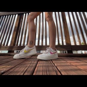 Women or men Nike air forces with yellow and pink paint